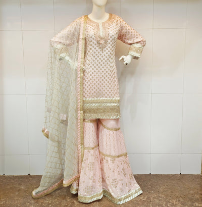 Traditional outfit in baby pink short kameez with light gold work geogette gharara n pint net dupatta