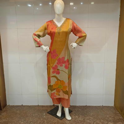 colorful straight suit with floral design and embellishments.